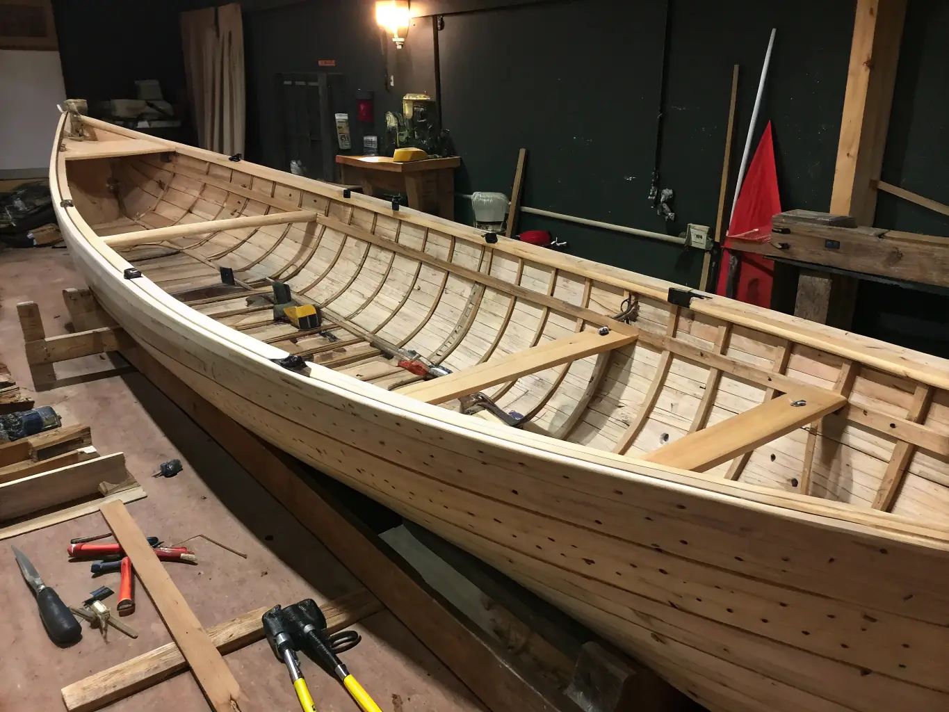 An image of a traditional doris boat being restored by volunteers, highlighting the preservation of maritime heritage.
